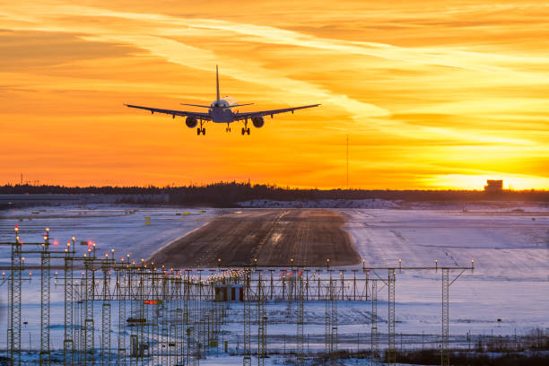 Airplane landing in sunset