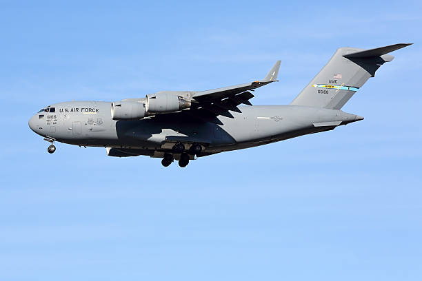 Silhouette of a C17 Cargo Aircraft taking off amid a snowy and icy landscape in Antarctica