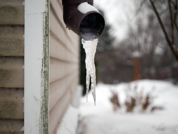 istock Frozen drain. Large icicles, snow, winter, house corner 639297136