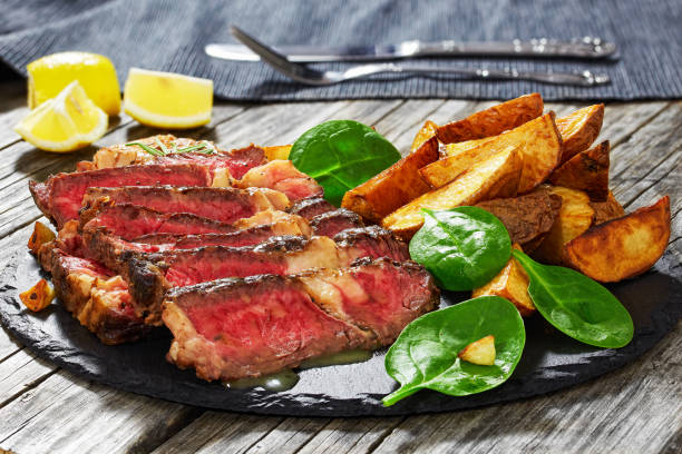 istock grilled medium-rare marbled ribeye steak cut in slices 639299642