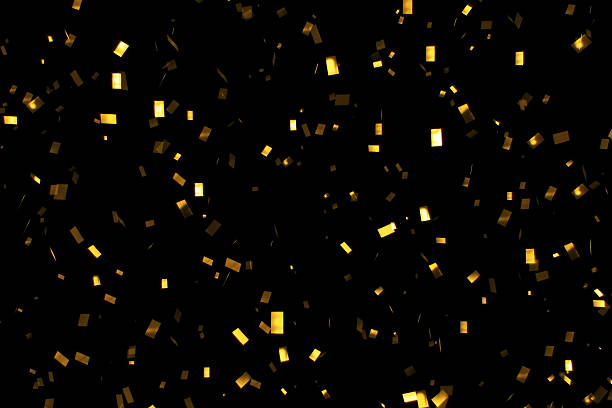 istock falling gold glitter foil confetti,  on black background 639300350