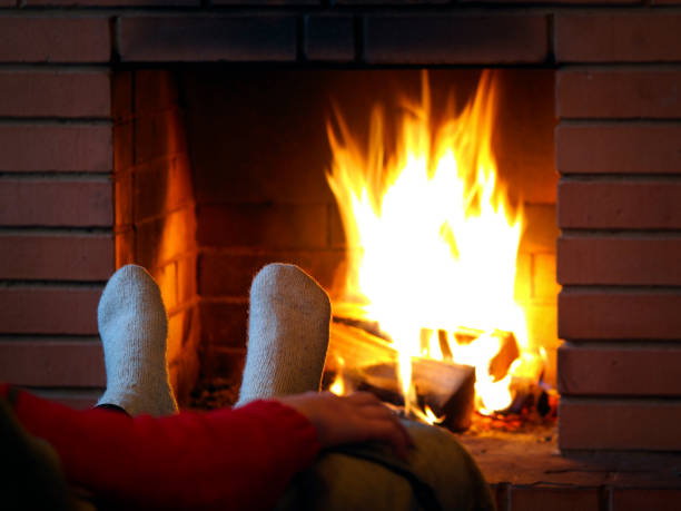 istock Feet in wool socks on a fireplace background 639303184