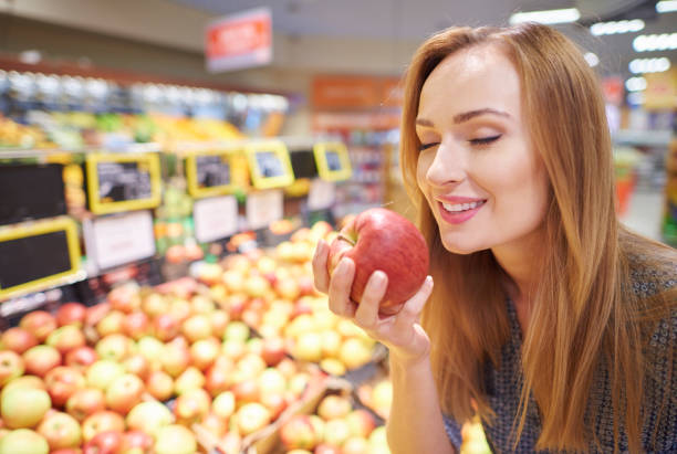 istock Woman choosing apples from grocery store 639303276