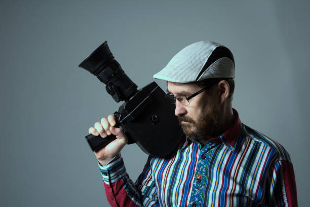 istock Thinking bearded man old retro film camera. 639304062
