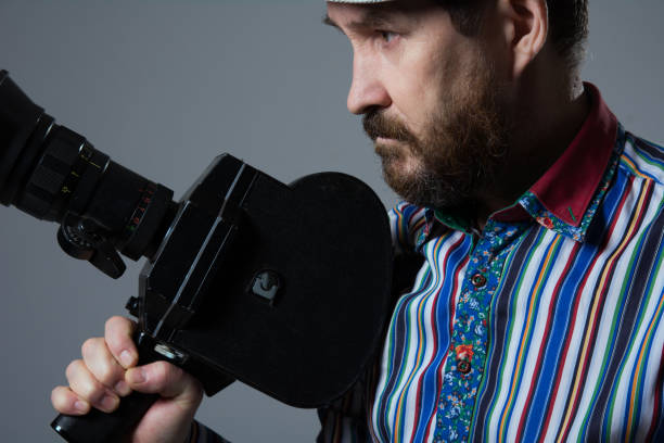 istock Bearded Man Movie Camera thoughtfully 639307062