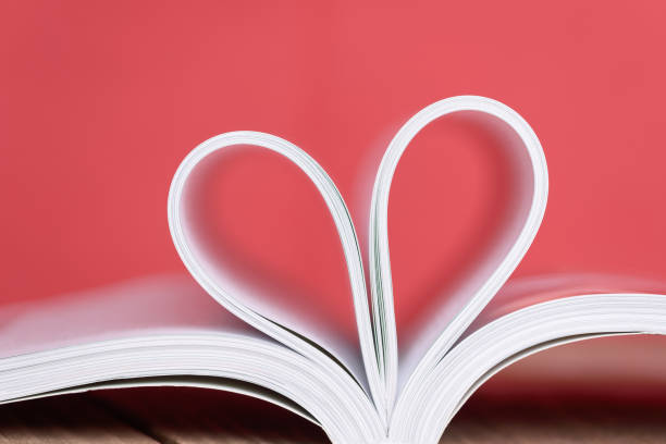 istock Valentine's day heart shape from book pages with red background. 639310906