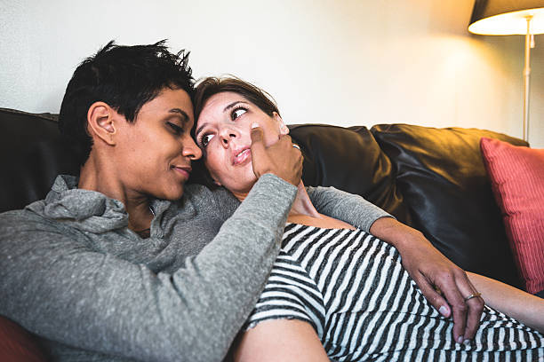 istock lesbian couple share cuddling on the couch 639311550