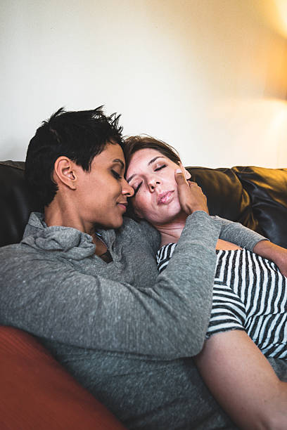 istock lesbian couple share cuddling on the couch 639311726