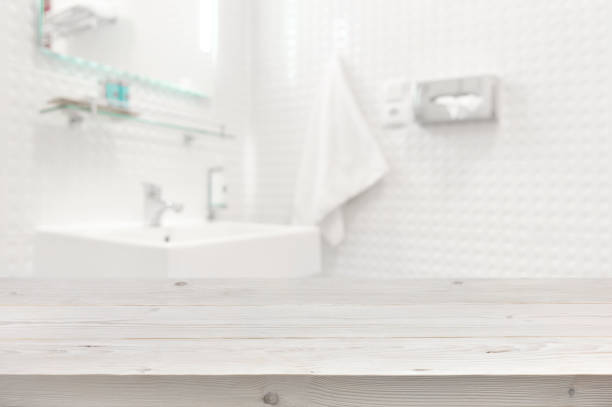 Wooden planks surface and blurred bathroom interior as background