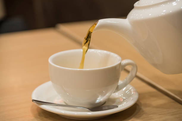 istock Teapot and cup of tea in cafe 639314632