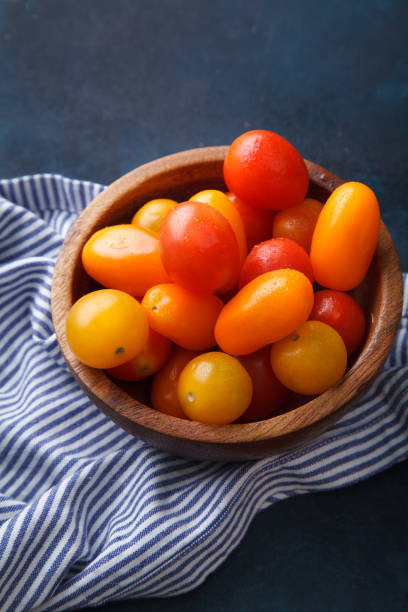 istock Cherry tomatoes with striped towel on blue background 639314676