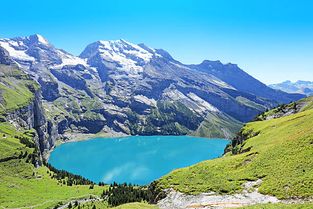Oeschinensee Lake Panorama Switzerland Oeschinensee in Berner Oberland region in central Switzerland as seen from the Panorama point on Heuberg hiking trail. Oeschinen Lake is an amazing hiking destination and a UNESCO World Heritage Site. lake oeschinensee stock pictures, royalty-free photos & images