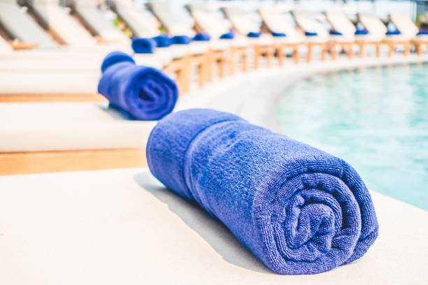 istock Towel on deck chair by poolside 639315592