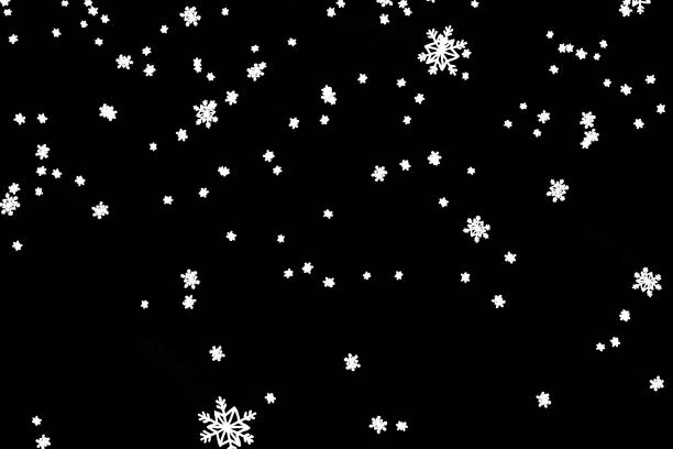 istock christmas black background with snowflakes falling snow from top 639316022