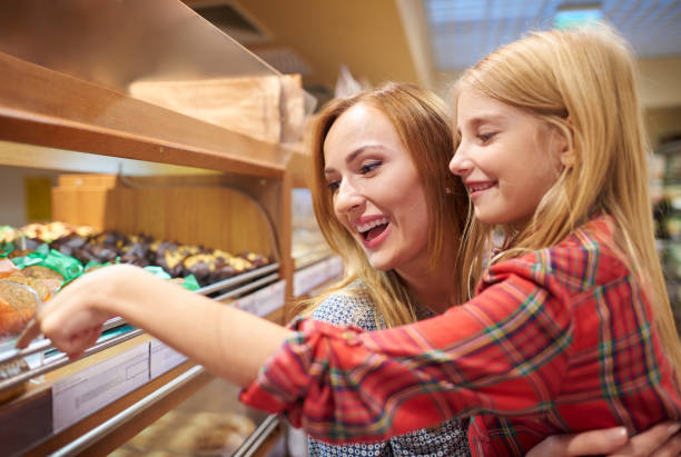 istock Mummy and daughter having fun while shopping 639317358