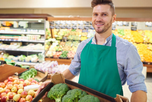 istock Young seller holding box of broccoli 639317772