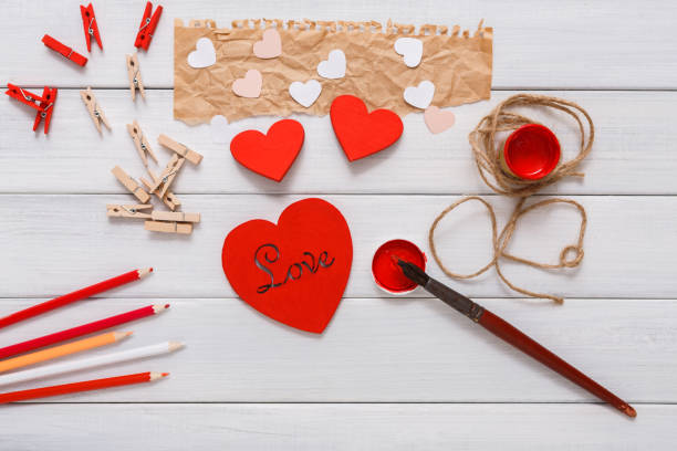 istock Valentine day diy handmade hearts making, top view on wood 639318428