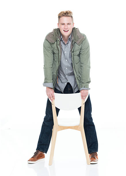 istock Smiling man standing with chair 639318492