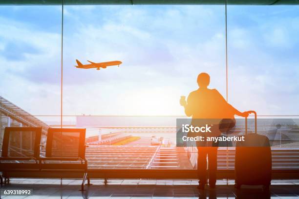 Happy Traveler Waiting For The Flight In Airport Stock Photo - Download Image Now - Airport, Travel, Commercial Airplane