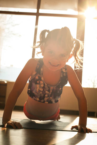 istock Little girl doing exercise at home. 639320344