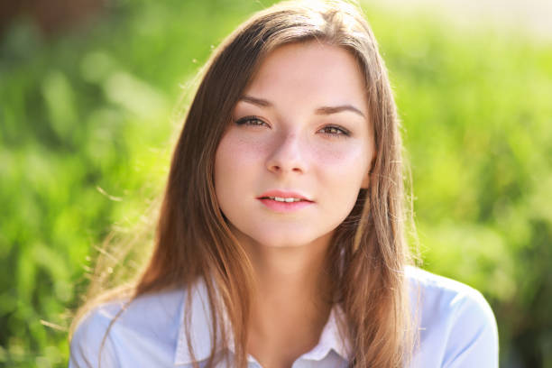 istock young woman in green park 639321020