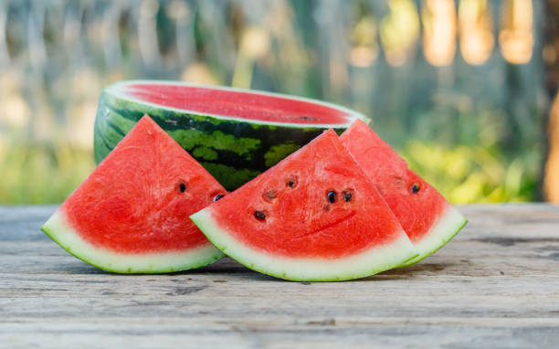 istock water melon slice on wood texture in nature background. 639321464