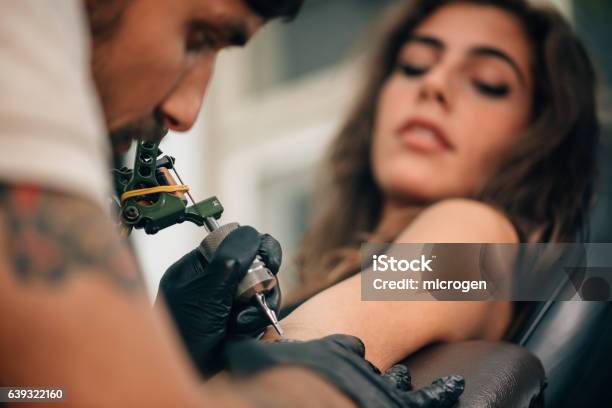 Tattooing Stock Photo - Download Image Now - Tattooing, Tattoo, Women