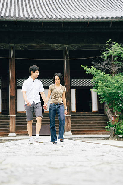 istock Cheerful japanese couple at the temple, front view 639323796