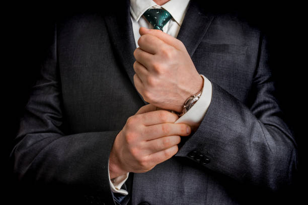 istock Business man fixing his cufflinks 639323950