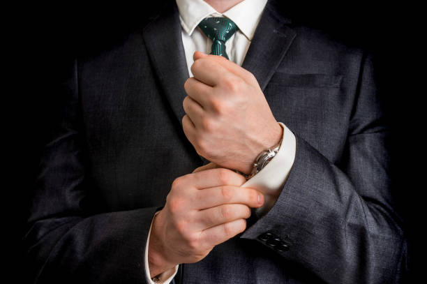 istock Business man fixing his cufflinks 639324020