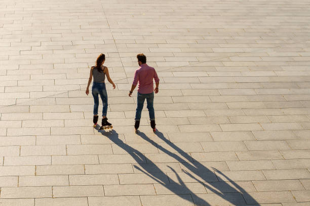 istock Back view of rollerblading couple. 639324036
