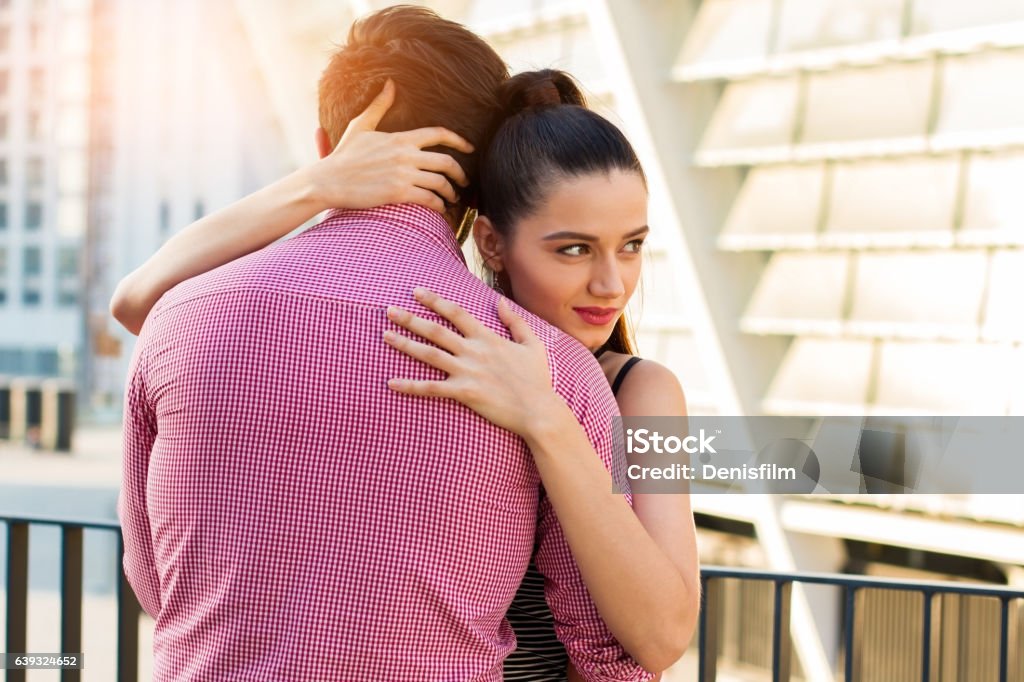 Young woman hugging man. Young woman hugging man. Guy and girl outdoors. Feelings get stronger. Adult Stock Photo