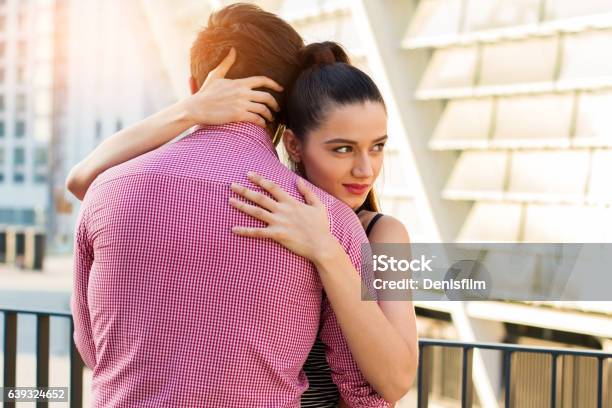 Young Woman Hugging Man Stock Photo - Download Image Now - Adult, Affectionate, Arts Culture and Entertainment