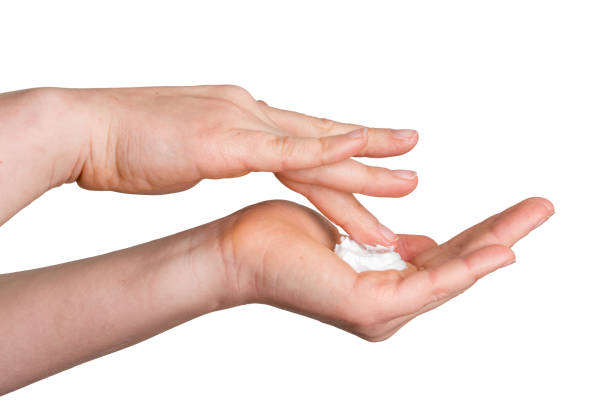 istock Female hands with cream isolated on white 639324742