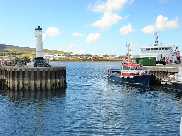Kirkwall town harbour Orkney Scotland Kirkwall capital of the orkney archipeligo has a hrabour for ferries and many working boats. The entrance to the inner harbvour is seen here with a fishing boat. orkney islands stock pictures, royalty-free photos & images