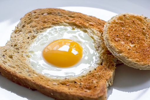 Novelty healthy breakfast meal of egg in toast. Egg fried in the centre of a slice of bread also known as egg in the basket.