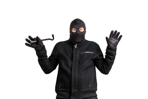 istock Arrested thief in balaclava with crowbar and raised arms 639326258