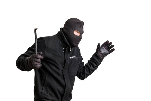 istock Masked thief in balaclava with crowbar isolated on white 639326460