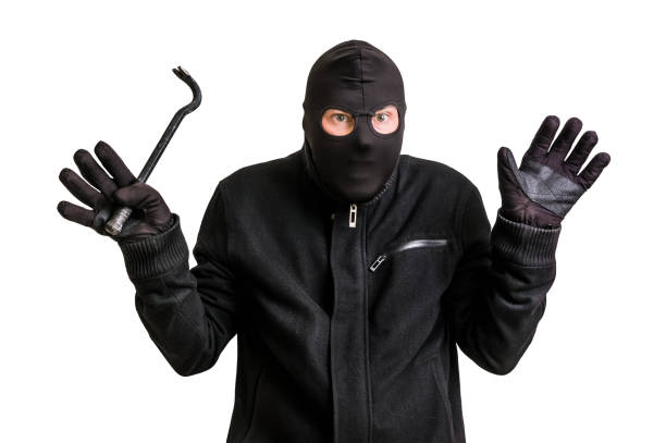 istock Arrested thief in balaclava with crowbar and raised arms 639326528