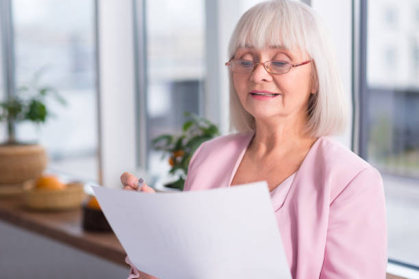 istock Serious businesswoman examining a document 639327250