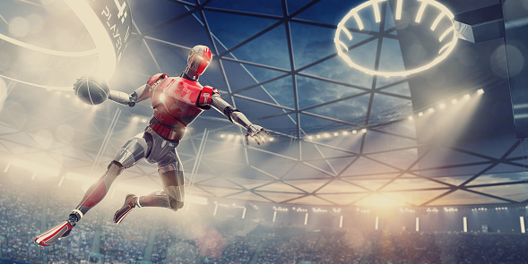A conceptual low angle image of a robot basketball player in mid air, jumping and holding basketball about to slam dunk to score. The cyborg is playing basketball in a game in generic indoor floodlit basketball arena, full of spectators. Both cyborg and location are fictional and CG created. 