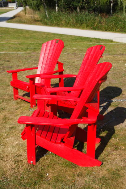 istock red wooden garden chairs on a meadow 639329028