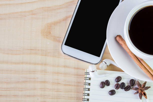 istock Coffee and open notebook with coffee beans on wooden table 639329514