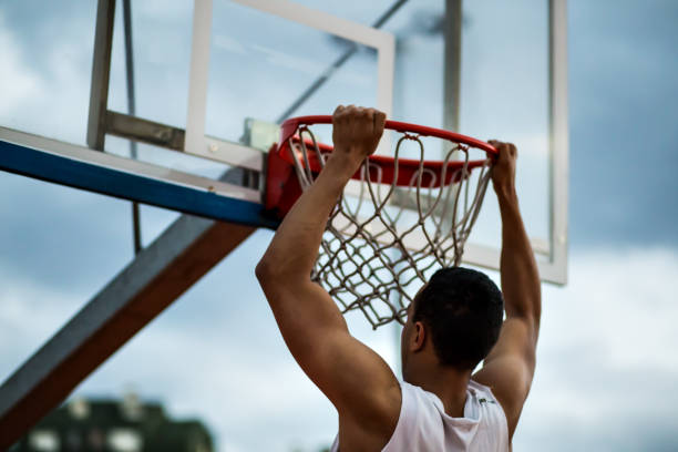 istock Basketball player makes slam dunk 639331110