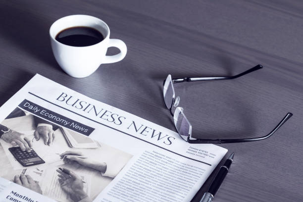 istock Newspaper with eyeglasses on wooden table 639331924
