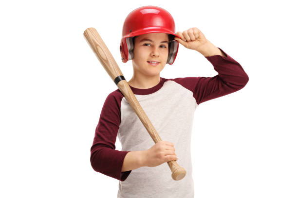 Baseball bat, shopping cart, and balls on batting cage in a sunny morning. Conceptual image about the professionalization of baseball from an early age.