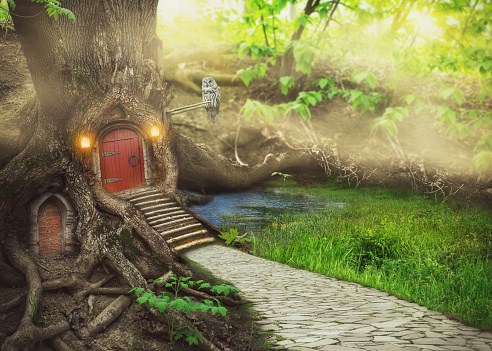 Fairy tree house in fantasy forest with stone road