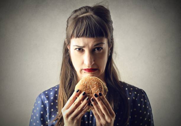 I don't like hamburger Portrait of a woman who doesn't want to eat her hamburger dont eat meat stock pictures, royalty-free photos & images