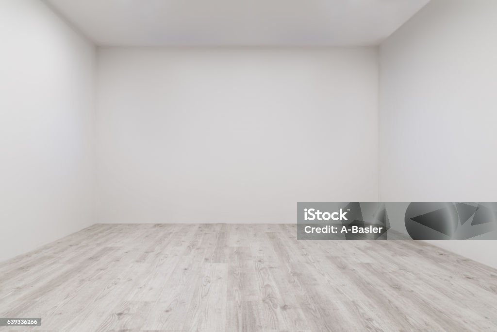 Room with whitewashed laminate and newly painted wall Empty room with whitewashed floating laminate flooring and newly painted white wall in background White Color Stock Photo