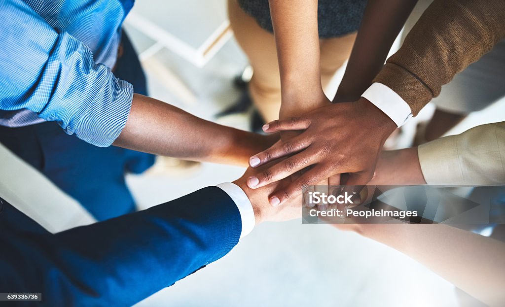 We are on a common mission Cropped shot of a group of businesspeople piling their hands on top of each other Teamwork Stock Photo